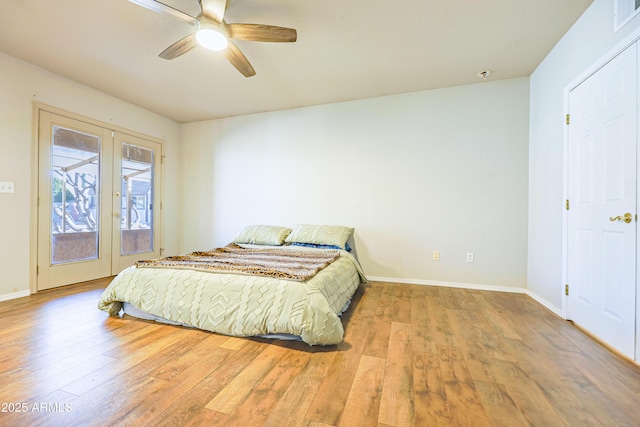 bedroom with ceiling fan, access to outside, light wood-type flooring, and french doors