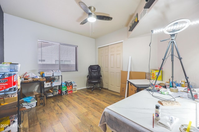 bedroom with a closet, dark hardwood / wood-style floors, and ceiling fan