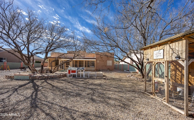 back of house with an outdoor structure