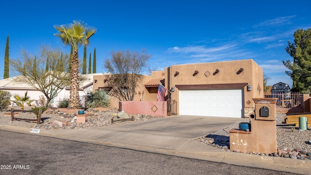 pueblo-style house with a garage