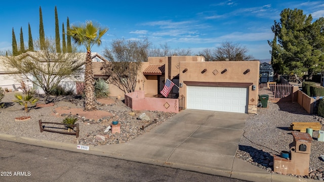 pueblo-style house with a garage