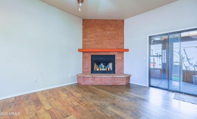 unfurnished living room featuring wood-type flooring and a fireplace