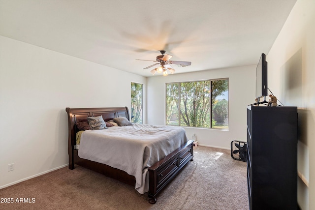 bedroom featuring a ceiling fan, carpet, and baseboards