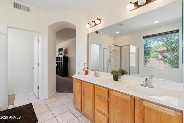 full bathroom featuring tile patterned floors, visible vents, a stall shower, and a sink