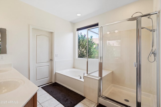 bathroom with a shower stall, double vanity, a bath, and a sink