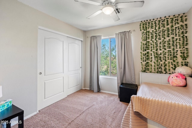 carpeted bedroom with baseboards, ceiling fan, and a closet