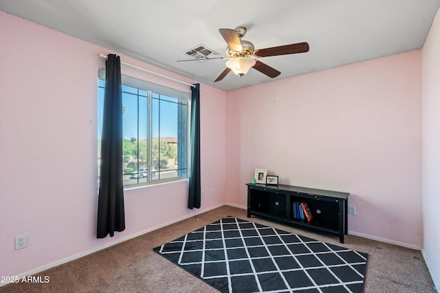 empty room with visible vents, a ceiling fan, baseboards, and carpet floors