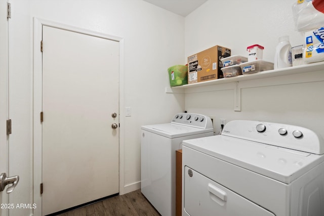 washroom with independent washer and dryer, laundry area, and dark wood finished floors