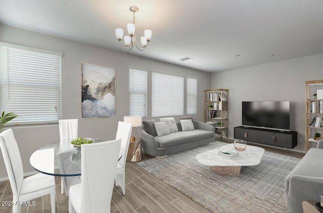 14870 W Encanto Blvd Unit 1106, Goodyear, AZ 85395 - living area featuring an inviting chandelier, wood finished floors, and visible vents