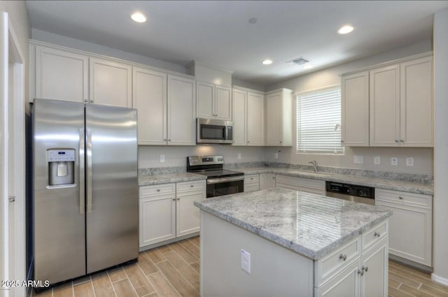 14870 W Encanto Blvd Unit 1106, Goodyear, AZ 85395 - kitchen featuring visible vents, a sink, appliances with stainless steel finishes, and wood finish floors