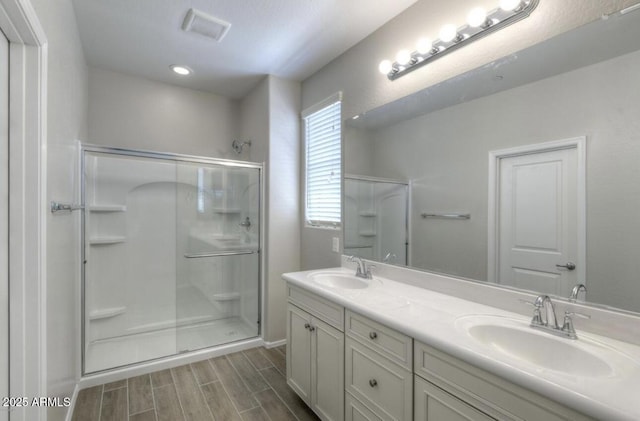 14870 W Encanto Blvd Unit 1106, Goodyear, AZ 85395 - full bath with wood finished floors, visible vents, a sink, and a stall shower