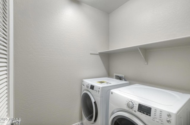 14870 W Encanto Blvd Unit 1106, Goodyear, AZ 85395 - laundry area with washer and dryer, laundry area, and a textured wall