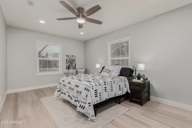 bedroom with ceiling fan and light hardwood / wood-style floors