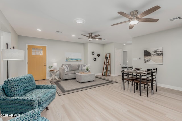 living room featuring ceiling fan and light wood-type flooring