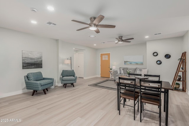 dining area with light hardwood / wood-style flooring and ceiling fan