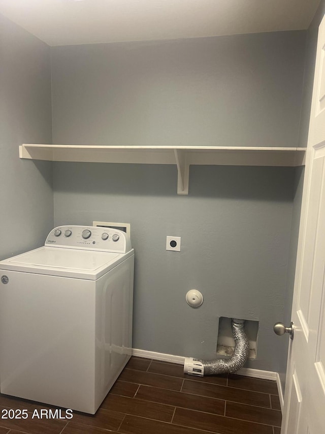 laundry area featuring laundry area, baseboards, wood tiled floor, and washer / clothes dryer