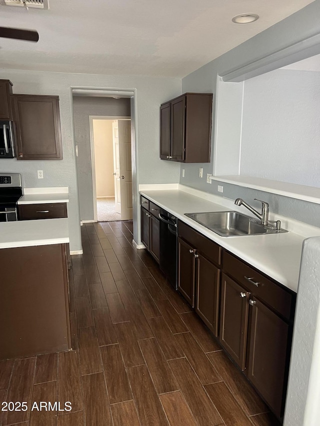kitchen with dark wood-style floors, light countertops, and a sink