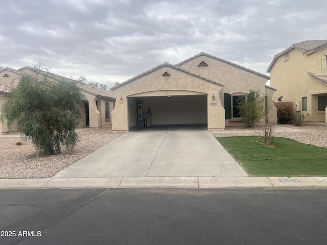 ranch-style house featuring a garage, stucco siding, a tiled roof, and driveway