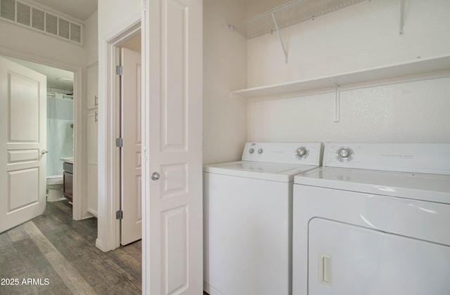 laundry room with washer and dryer, laundry area, dark wood-style flooring, and visible vents