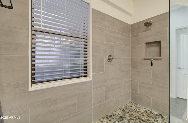 bathroom with a tile shower