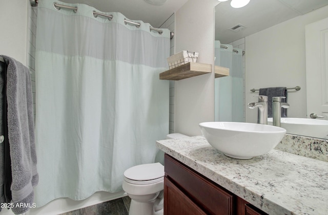 bathroom featuring visible vents, wood finished floors, vanity, toilet, and shower / tub combo with curtain