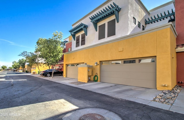 view of home's exterior with an attached garage and stucco siding