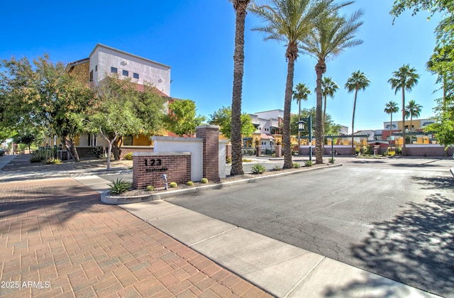 view of street featuring sidewalks, curbs, and street lights