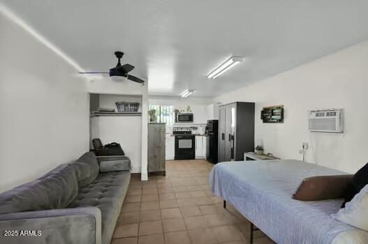 22351 S Sossaman Rd, Queen Creek, AZ 85142 - bedroom featuring a wall unit AC, light tile patterned floors, and freestanding refrigerator