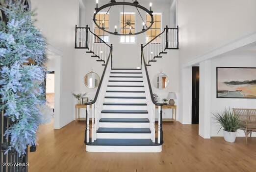 22351 S Sossaman Rd, Queen Creek, AZ 85142 - stairs with wood finished floors, a towering ceiling, and a chandelier