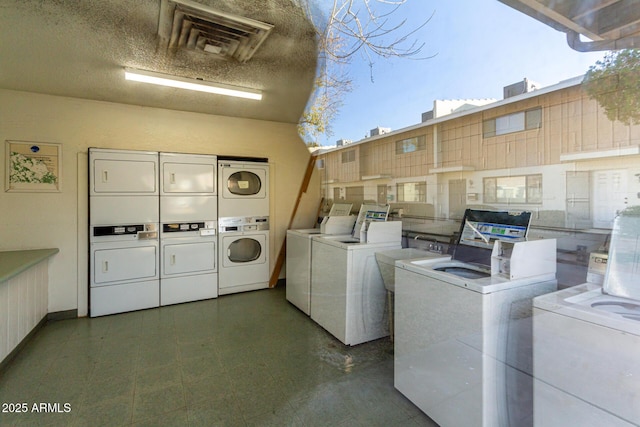 common laundry area with washer and dryer, stacked washer and dryer, and a textured ceiling