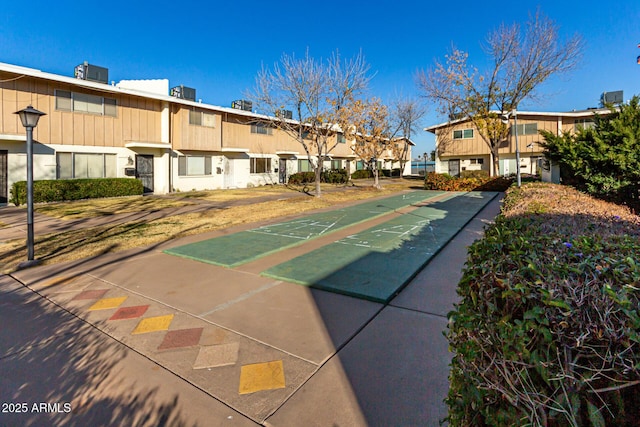 view of community with a residential view and shuffleboard