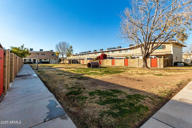 view of yard with a residential view and fence