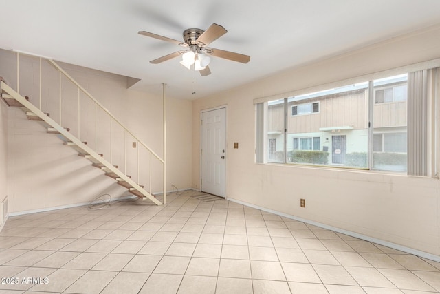 foyer featuring light tile patterned flooring, stairs, and a ceiling fan