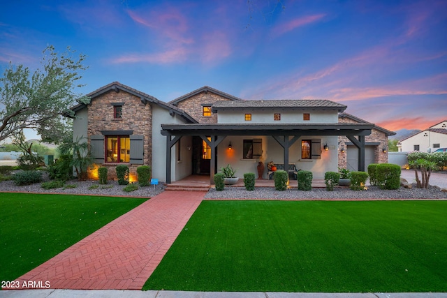 view of front of house with a lawn and a porch