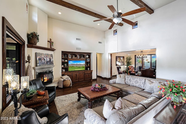 living room featuring beamed ceiling, ceiling fan with notable chandelier, high vaulted ceiling, and hardwood / wood-style flooring