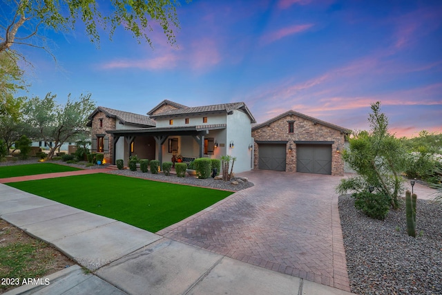 view of front of house featuring a lawn and a garage