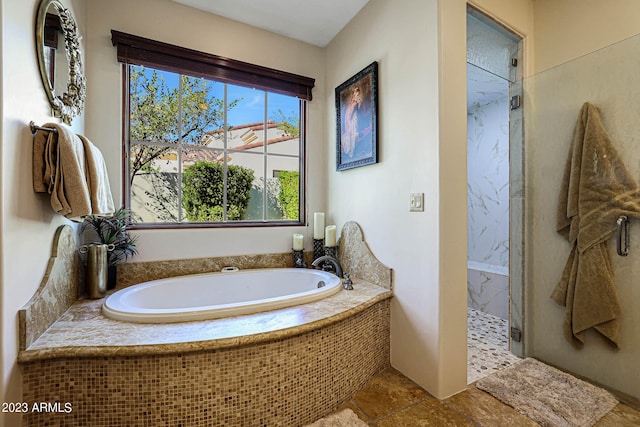 bathroom featuring separate shower and tub