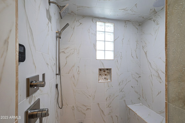 bathroom with tiled shower