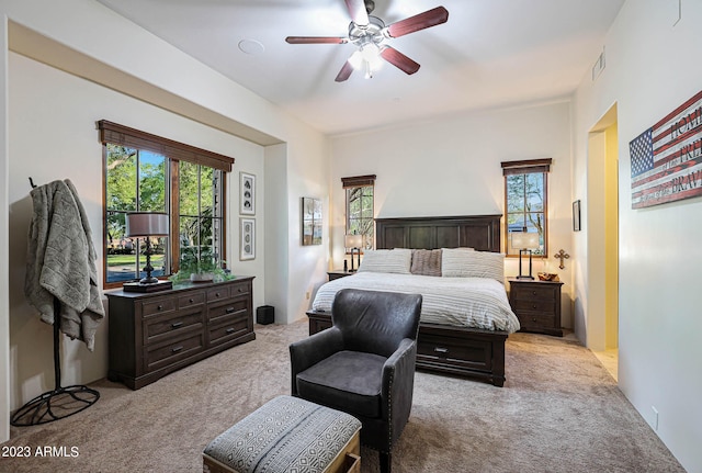 bedroom featuring ceiling fan and light colored carpet