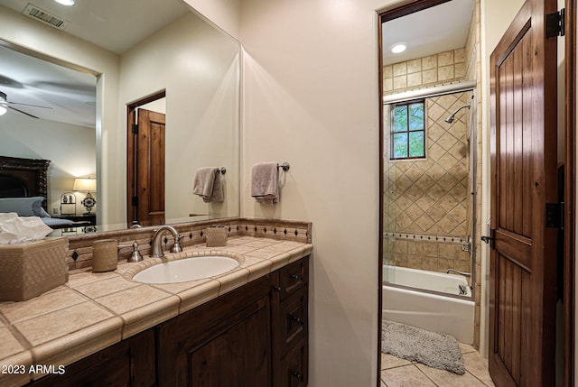 bathroom with ceiling fan, vanity, bath / shower combo with glass door, and tile patterned floors