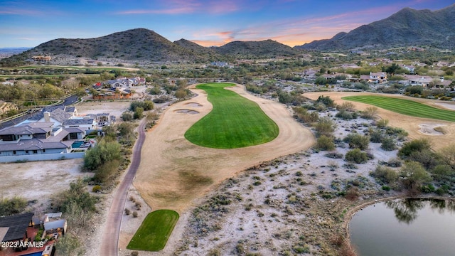 aerial view at dusk featuring a water and mountain view