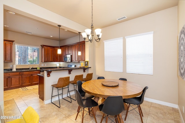 dining room featuring an inviting chandelier and light tile patterned floors