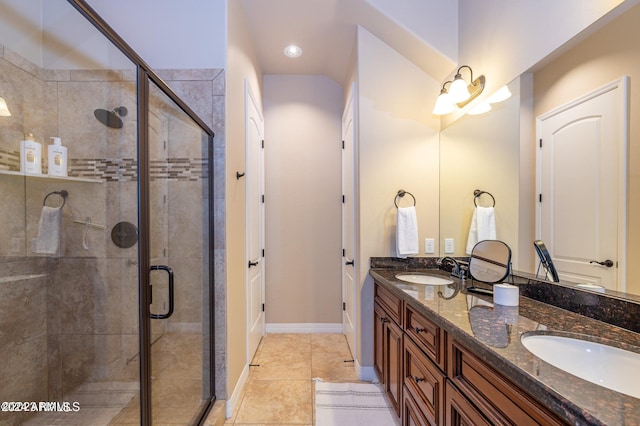 bathroom with vanity, a shower with shower door, and tile patterned floors