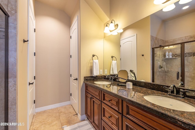 bathroom with vanity, an enclosed shower, and tile patterned floors