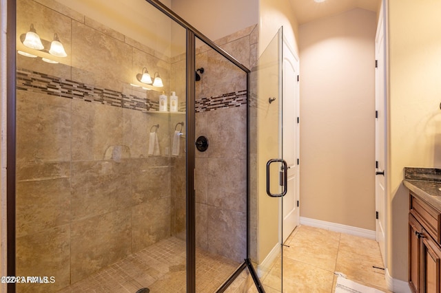 bathroom featuring vanity, tile patterned floors, and a shower with shower door