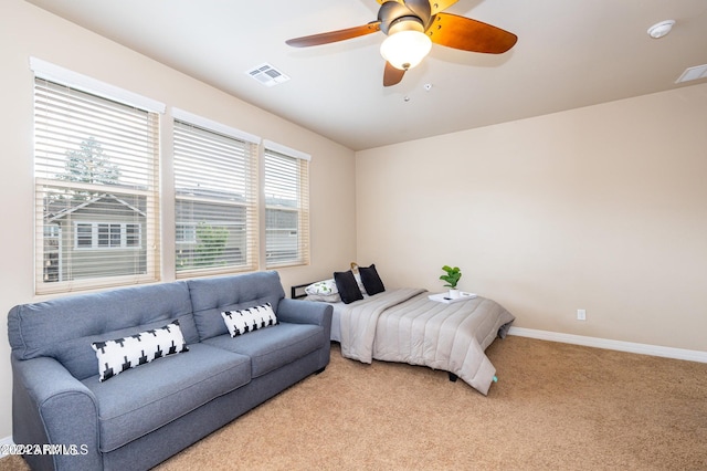 bedroom with ceiling fan, multiple windows, and light colored carpet