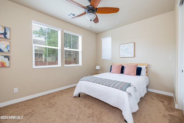 carpeted bedroom with ceiling fan