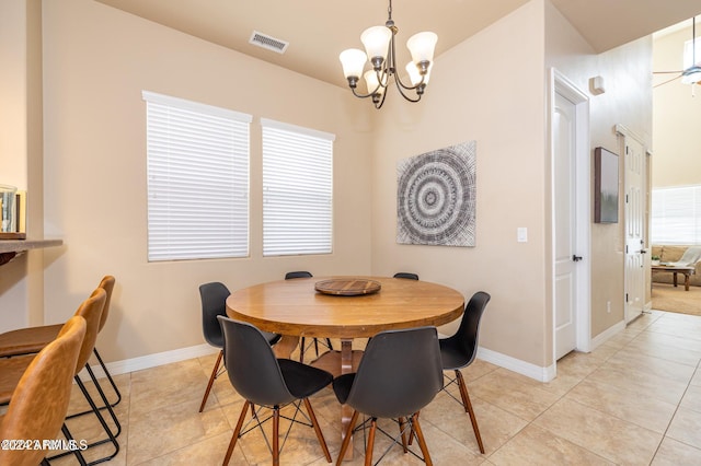 dining room featuring light tile patterned flooring and ceiling fan with notable chandelier