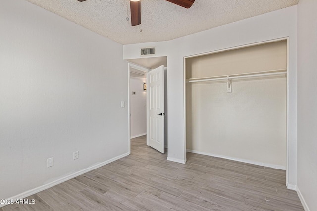 4845 W Evans Dr, Glendale, AZ 85306 - unfurnished bedroom with wood finished floors, a textured ceiling, a closet, and a ceiling fan