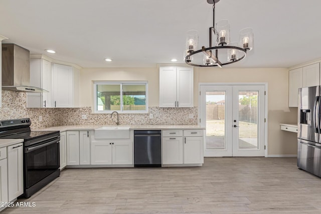 4845 W Evans Dr, Glendale, AZ 85306 - kitchen with stainless steel appliances, wall chimney exhaust hood, a chandelier, light countertops, and white cabinets